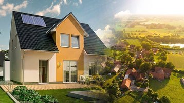 Einfamilienhaus mit Solaranlage vor einer ländlichen Ortschaft im Grünen